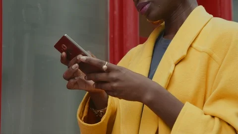 Close-up portrait of wealthy African woman working remotely on her mobile device Stock Footage 120550737