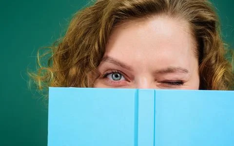 Close up portrait of winking teacher with notepad. School supplies. Back to.. Stock Photos