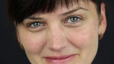 Close up portrait woman, macro, indoors. On a black background. Stock Footage