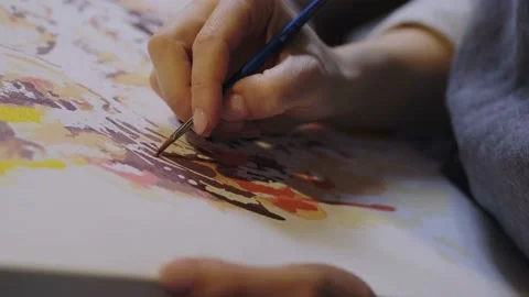 Close-up portrait of a woman's hands drawing with a brush painting by numbers on Video stock 201951794