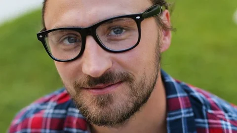 Close up portrait of young attractive man in the glasses looking to the camera Stock Footage