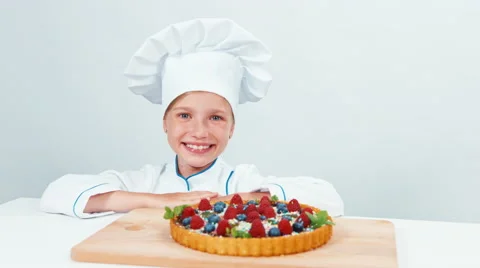 Close up portrait young baker examines and touching using finger chocolate cake Stock Footage 67256750