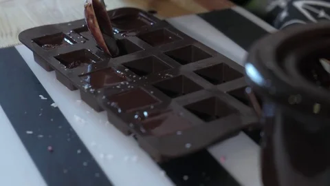 Close up portrait young baker examines and touching using finger chocolate 4k Stock Footage