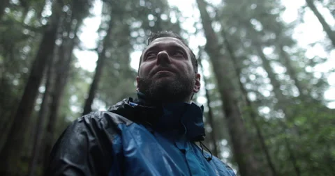 Close-up portrait of a young bearded man sitting in nature Stock Footage 244139377