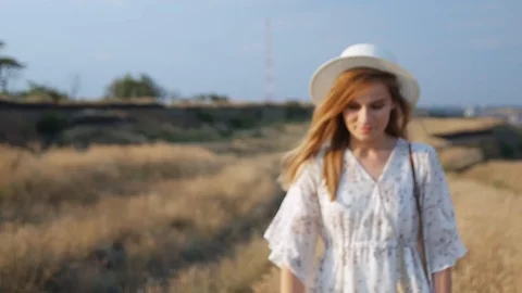 Close up portrait young beautiful smiling woman in white dress and wicker hat Stock Footage 112874845