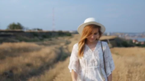 Close up portrait young beautiful smiling woman in white dress and wicker hat Stockbeeldmateriaal 112874848