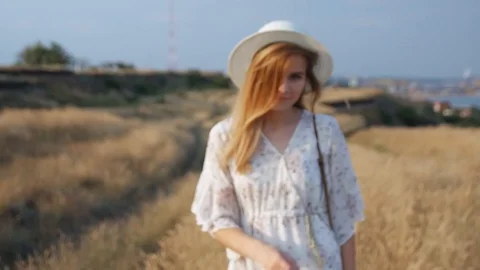 Close up portrait young beautiful smiling woman in white dress and wicker hat 動画素材 112874852