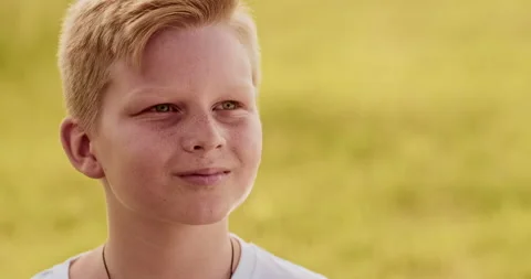 Close up portrait of young boy looking at camera moving slowly, out of city Stock Footage 302551846