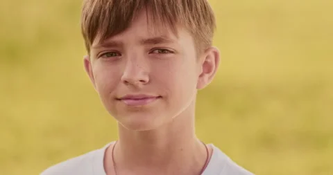 Close up portrait of young boy looking at camera moving slowly, out of city Stock Footage 304752038