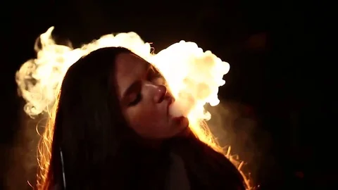 Close-up portrait of a young brown-haired woman, sexy smoking hookah on a dark  Stock Footage 82254808