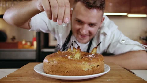 Close-up Portrait Young Chef Decorating Dessert Organic Cake at Kitchen Table 4k 142635603