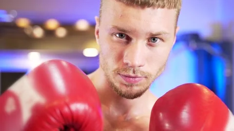 Close-up portrait of a young confident serious boxer man. Face of a guy athlete  Stock Footage 143223885