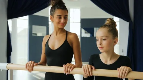 Close up portrait of young dance teacher and her student looking to each other 動画素材 77139085