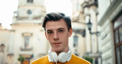 Close-up portrait of the young guy with blonde hair and freckles wearing the Stock Footage 92006740