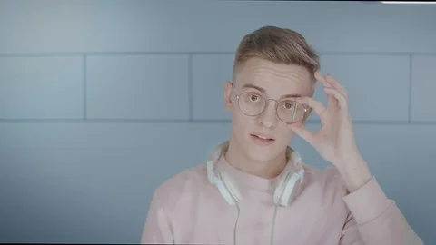 Close-up Portrait of a young guy with glasses. The boy smiling, flirting Stock Footage 116735118
