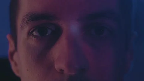 Close-up portrait of young guy watching movie tv film at night. Reflection on Stock Footage 145969994