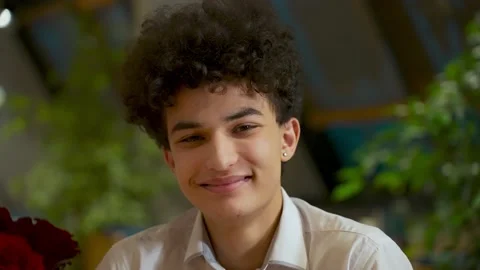 Close-up portrait of a young handsome guy zoomer mixed race with an african Stock Footage 168368828