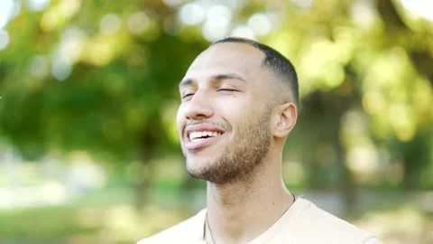 Close up portrait young happy handsome man standing in nature between forest  Stock Footage 219550767