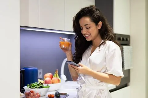 Close up portrait of young joyful Caucasian woman in white robe smiling and Stock Photos
