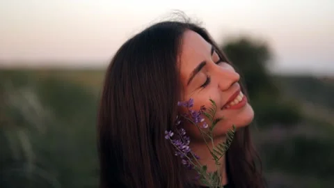 Close-up portrait of a young long-haired woman in nature Stock Footage 242844493