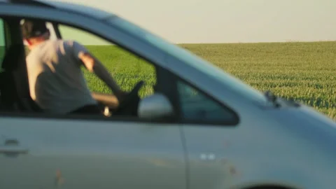 Close up portrait of a young man with cap farmer getting out of the car near Stock Footage 213664876