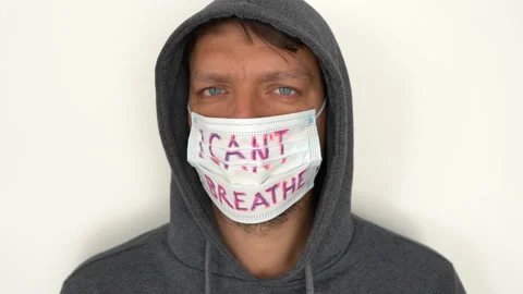 Close portrait of a young man in a gray hoodie with a mask on his face. The mask Stock Footage 142464971