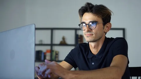 Close-up portrait of Young Man Looking at Monitor, Browsing the internet Stock Footage 93238087