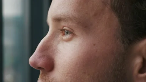 Close-up Portrait of a young man looking into the distance. Blue eyes of a young Stock Footage 146019222