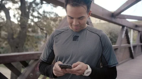 Close up portrait of young man using smartphone connected to web, chats with Stock Footage 104490240