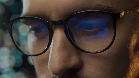 Close-up portrait of a young man working at the computer. Laptop display is Stock Footage 164161136