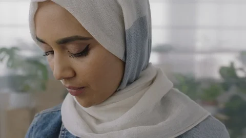 Close up portrait of young muslim business woman turns head looking at camera Stock Footage