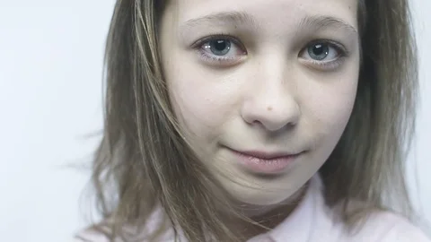 Close-up portrait of a young naive, kind girl in slowmo. Stock Footage 86972679