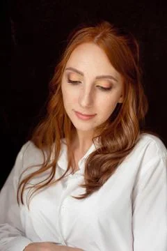 Close up portrait of young red-haired woman on black background Stock-Fotos