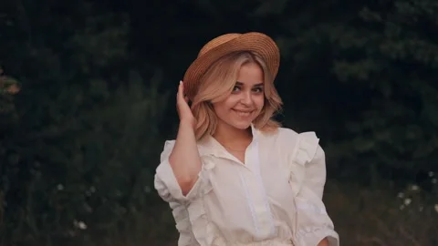 Close up portrait of young smiling attractive blonde woman in hat outdoors. Stock Footage 247989138