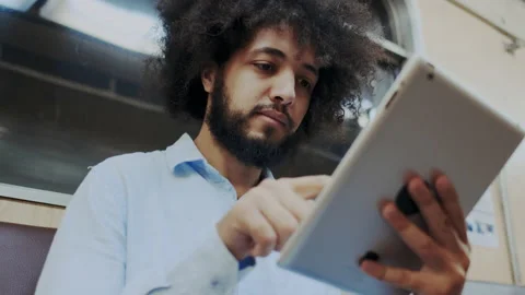 Close-Up Portrait of Young Stylish Hispanic Man Using Cellular Mobile Device in Stock Footage 136069703