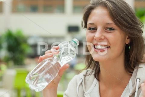 Close up portrait of a young woman drinking water Stock Photos