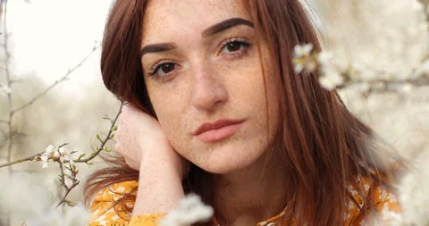 Close up portrait of the young woman's face is full of freckles. beautiful red Stock Footage 129355817