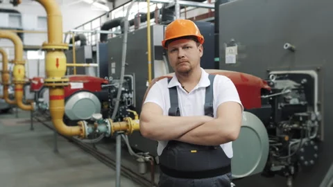 Close-up portrait of a young worker in a uniform and a hard hat. Stock Footage 306815422