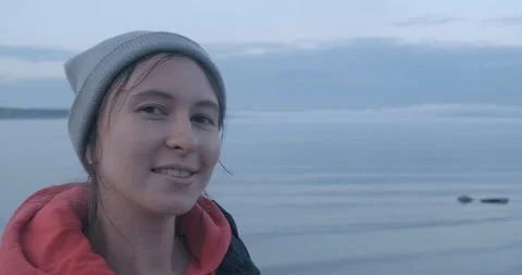 Close-up Of Posing Girl. Face. Stands on Background of Foggy Huge Lake. Camping 動画素材 134382748