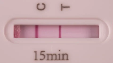 Close up of a Positive COVID-19 (Corona) Rapid Antigen Test in a few seconds Stock Footage 156300593