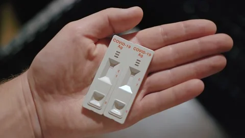 Close up of a positive test for coronavirus in a man's hand. Stock Footage 143348386
