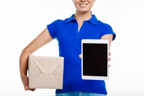 Close up of a post office worker facing her tablet screen towards the camera. Stock Photos