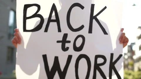 Close-up poster with the inscription back to work. Social protests during Stock Footage 130851843