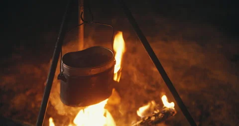 Close-up pot on campfire on camping trip at night. Boiling water, cooking dinner Stock Footage 140290267