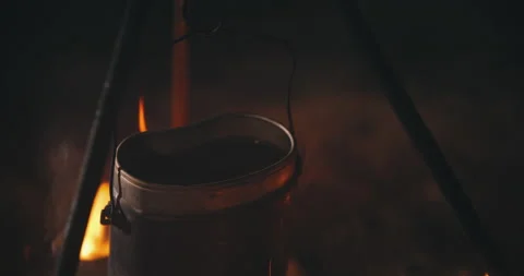 Close-up pot on campfire at night. Boiling water, cooking dinner on fireplace Stock Footage 140146317