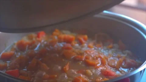 Close-up of a pot simmering vegetables to make pumpkin soup Stock Footage 285264884