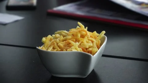 Close-up of potato chips in a container holding by hand in a restaurant 動画素材 164554763