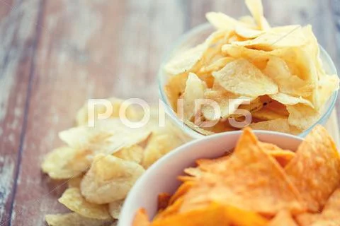 Close Up Of Potato Crisps And Corn Nachos On Table