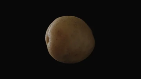 Close-up, potato tuber in a dragging motion on a black background Stock Footage 247567633