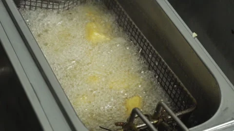 Close up potatoes are fried in a restaurant Deep fryer in slow motion, oil boils Stock-Footage 103245221